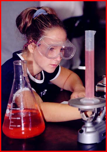 Girl using a balance to find density