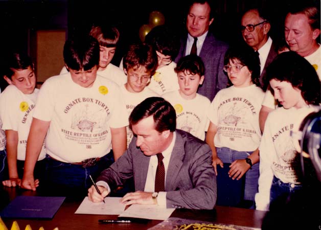 Governor John Carlin signing the famous ORNATE BOX TURTLE bill in Caldwell, Kansas on Monday, 14 April 1986